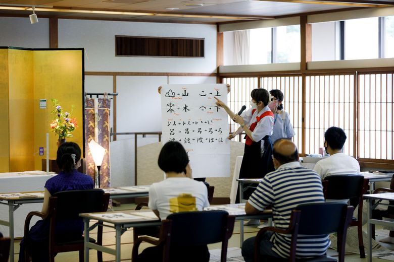 The instructor introducing pictographs to participants in English