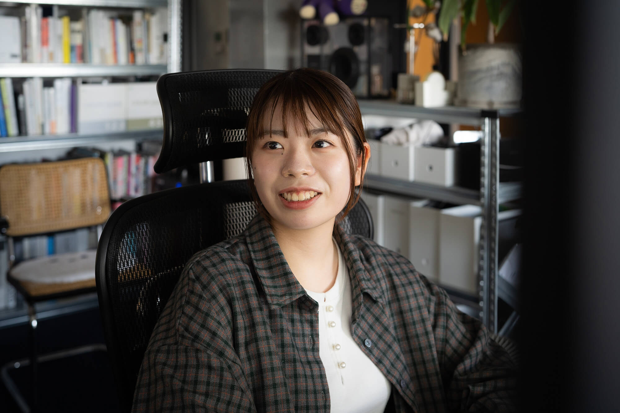 安達友香さんがPCの前で笑っている写真