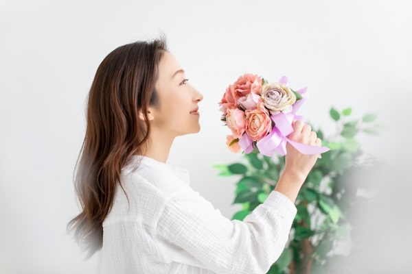 花の香りを楽しむ女性