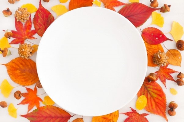 A plate with autumn leaves in the background