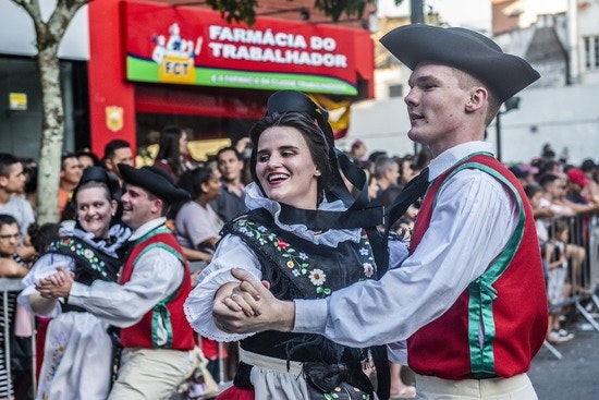 People dancing merrily in traditional costumes.