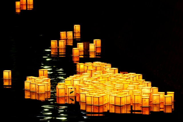 Paper lanterns floating down a river.