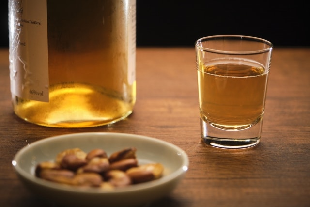 Whiskey shot with a side of nuts.