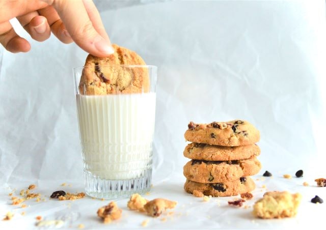 Dipping cookie into a glass of milk