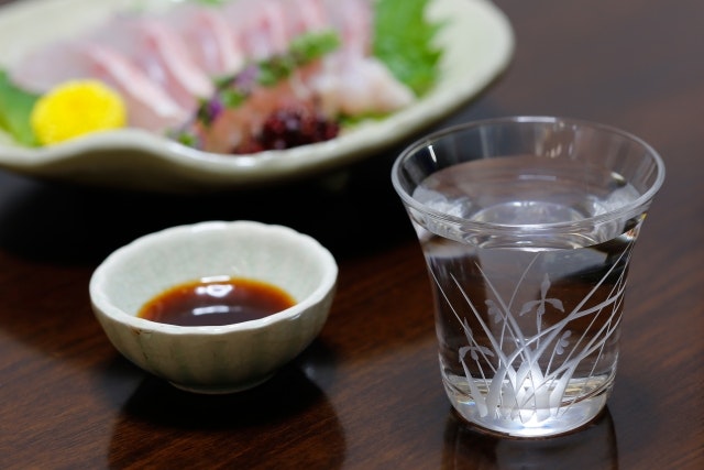 Sake alongside a platter of sashimi.