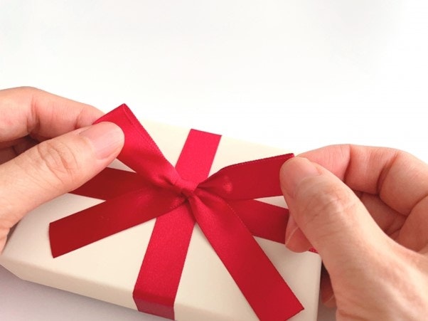 Christmas gift wrapped with red ribbon.