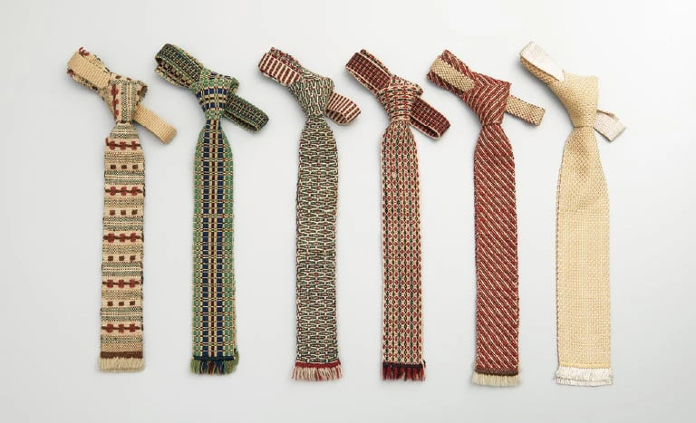 Six hand-woven *niniguri* neckties in different colours and patterns laid side by side