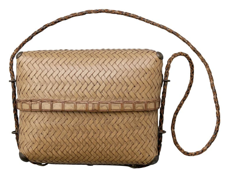 A box-shaped shoulder bag of plaited bamboo with a braided strap