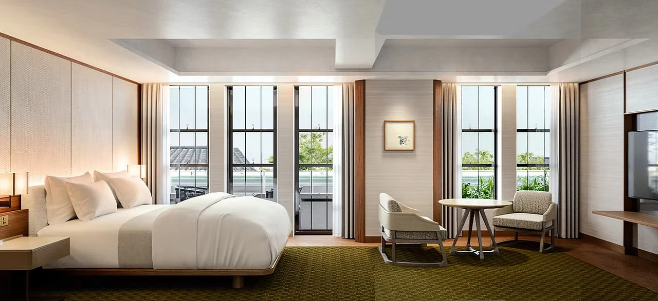 A guest room with tall gridded windows looking out over Gion's rooftops