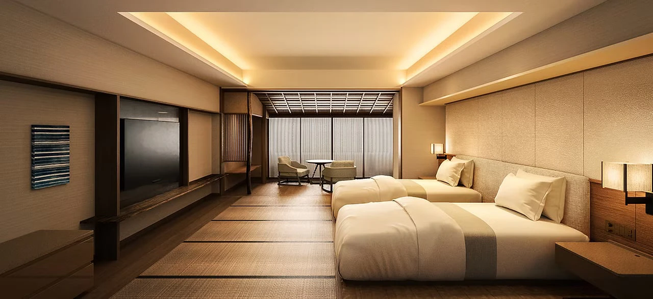 A twin guest room with wooden floors and soft indirect lighting