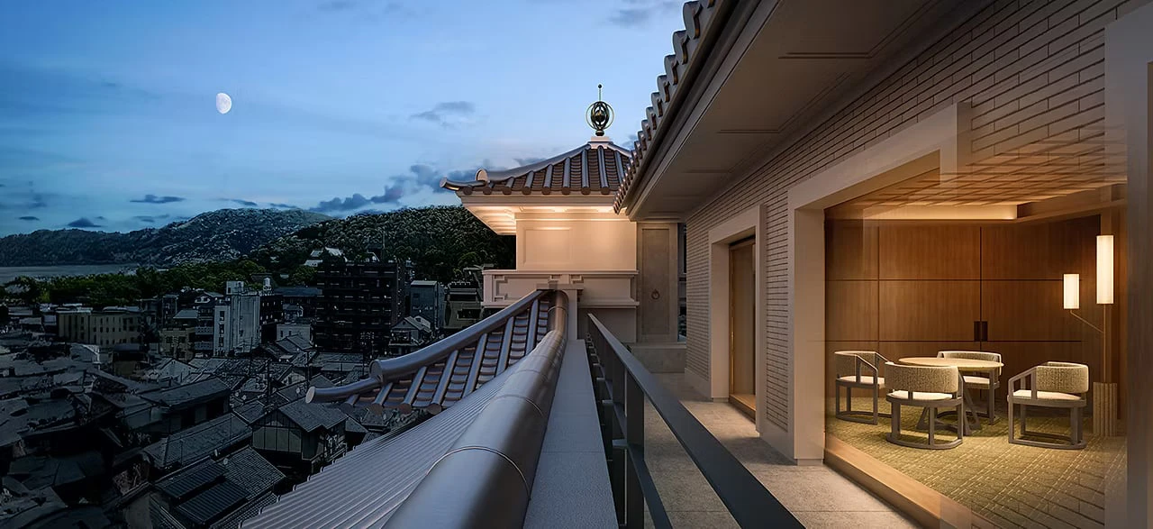 Gion's rooftops seen at dusk from the top of the historic building, with a glass-walled lounge alongside