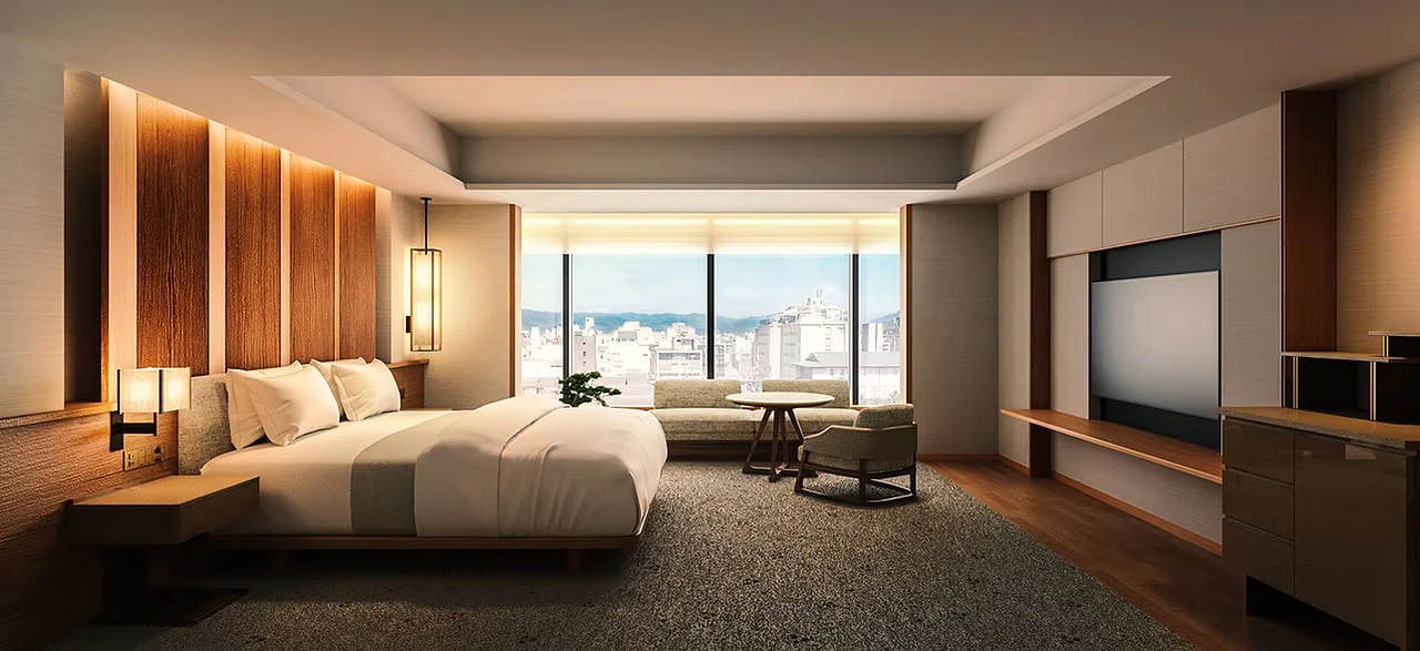 A guest room with a large bed set against wood panelling and a window overlooking the city
