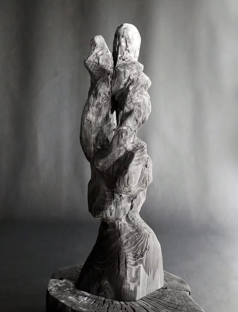 A tall charcoal sculpture twisting upwards from its base
