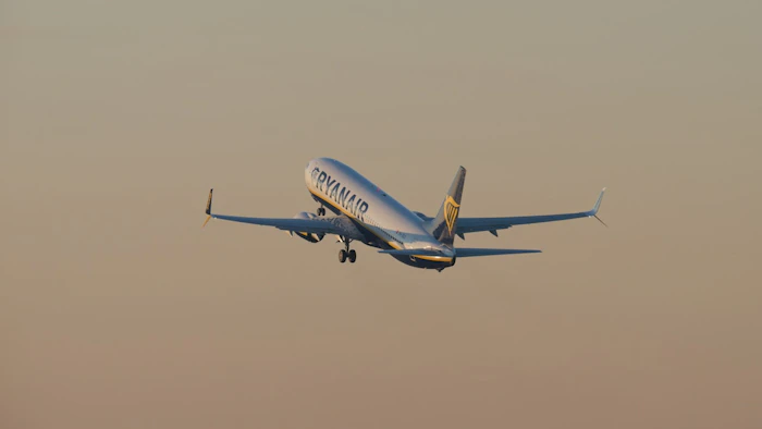 Airplane ascending into a hazy sky.