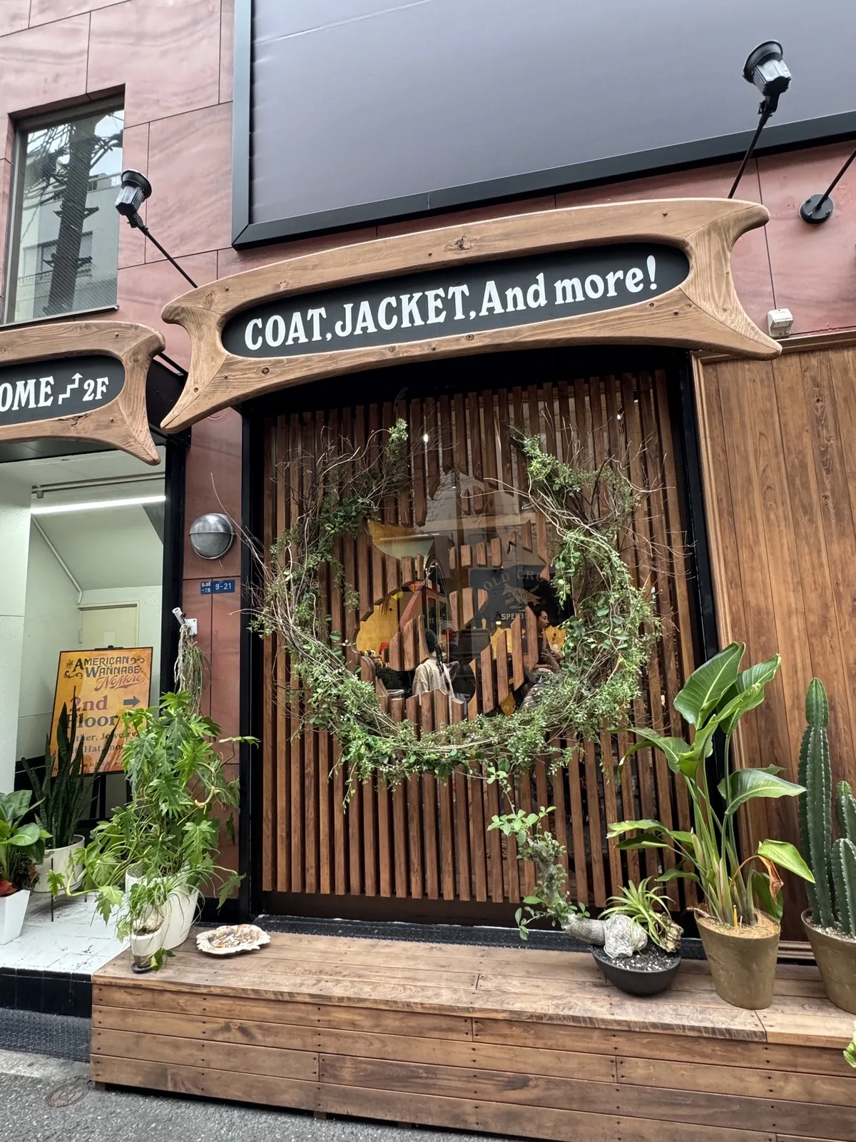 アーチ状の木の看板と植栽が並ぶ、改装後のAMERICAN WANNABE店頭
