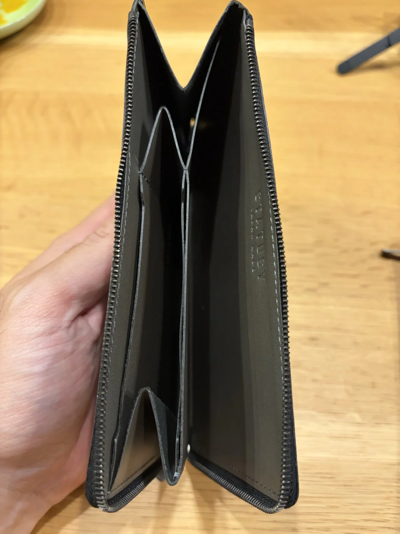 前作トープを開けた内側。内装もトープ系で、革と同じ色の STATUSY のロゴが見える